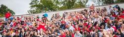 Crowd cheering at Montclair State University football game.